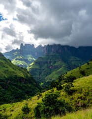 Lush green mountains under a dramatic sky