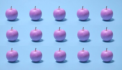 Pinkish apples symmetrically arranged against a blue backdrop