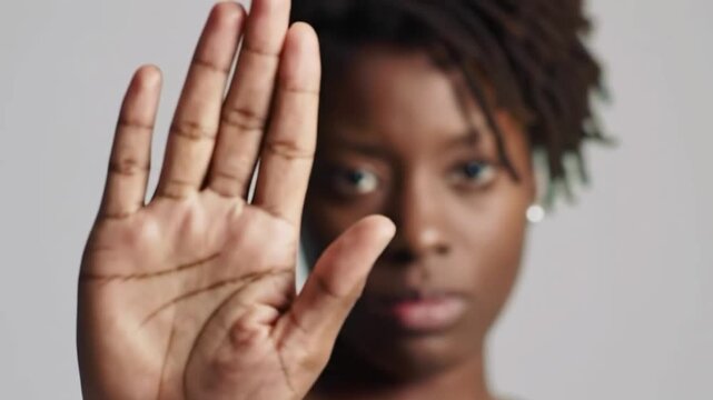 Woman holding up her hand in a stop gesture