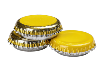 Three shiny new yellow and silver bottle caps stacked on a black background