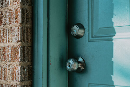 blue door entrance to brick house - Powered by Adobe