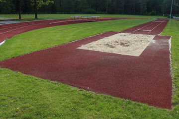 An empty long jump pit on the track.