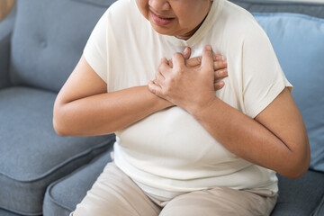Chest pain, attack chest, emergency heartbeat asian senior woman holding hand on chest, suffering symptom from pain, heart disease problem of aged anxiety cardiac. Health care of cardiology concept.