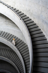 Elegant Spiral Staircase with a Woman in a Hat