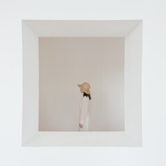 Minimalist Portrait of a Woman in a Hat Inside a White Frame