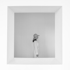 Minimalist Portrait of a Woman in a Hat Inside a White Frame