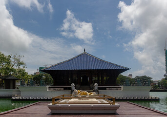 The iconic blue-roofed pavilion of the Seema Malaka Buddhist Temple on Beira Lake with a reclining...
