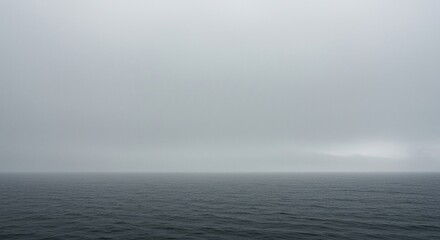 A vast, serene ocean landscape shrouded in a thick blanket of rolling fog, creating a mysterious and tranquil atmosphere with muted colors ,dreamy ,weather ,misty
