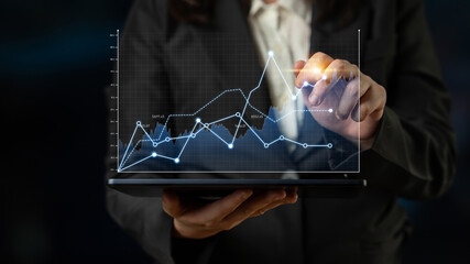 A business professional is analyzing data trends on a tablet in a modern office. The image showcases graphs and charts that represent performance and growth analytics. Scalp