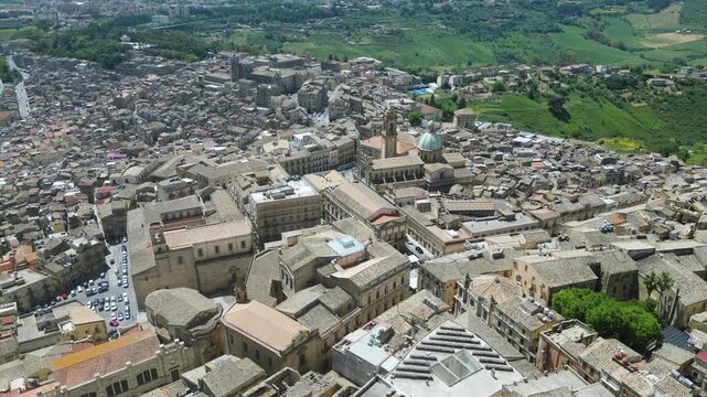 Aerial drone footage of Caltagirone, Sicily: Baroque town with historic buildings, colorful ceramics, and scenic streets. Ideal for travel, culture, and heritage projects.