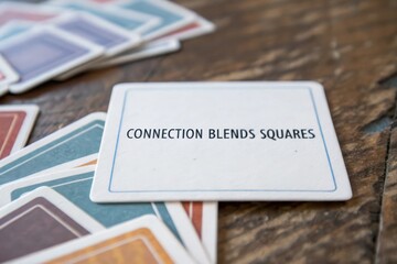 White game card with connection blends squares text on wood