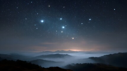 A vast night sky filled with bright stars and a prominent constellation hovers over misty rolling hills with a distant horizon glow