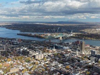 Autumn aerial view of Montreal downtown skyline with high-rise buildings under cloudy sky. g.
