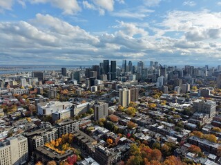 Fototapeta premium Autumn aerial view of Montreal downtown skyline with high-rise buildings under cloudy sky. g.