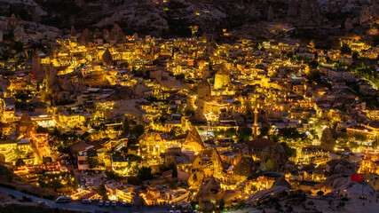 This breathtaking aerial photograph captures the magical atmosphere of the Goreme Open Air Museum in Cappadocia, Turkey, during the evening hours. 