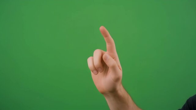 Hand pointing upwards against a green screen background for visual communication