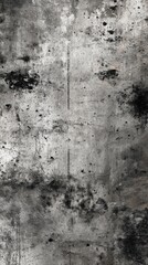 Obraz premium A textured, abstract surface featuring shades of gray with dark spots and marks, evoking a raw, industrial aesthetic.