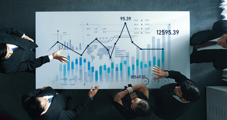 Team of professionals engaged in a business meeting discussing data analysis with financial graphs, showcasing collaboration and strategic decision-making in a corporate environment. Scalp