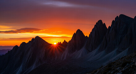 A breathtaking sunset illuminates the jagged peaks of the dolomites, casting a warm glow over the rugged landscape and creating a stunning alpine vista