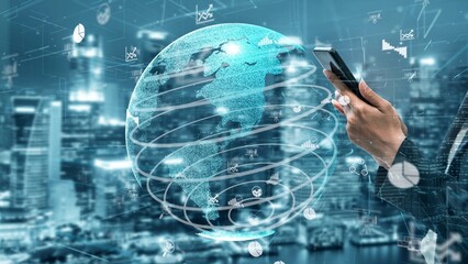 A person holds a smartphone while interacting with a digital globe surrounded by interactive data visualizations against a futuristic city background, representing global connectivity. Xenic