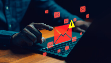 Cybersecurity concept showing a person receiving phishing or spam email alerts on a laptop....