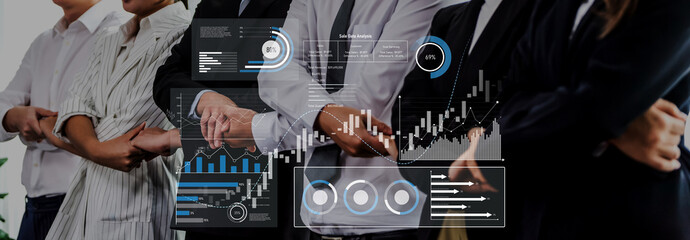 A diverse business team stands confidently in a modern office, showcasing financial charts and graphs on digital screens, symbolizing teamwork and analysis. Trope