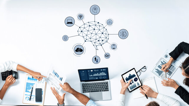 A modern business team collaborates at a sleek workspace, utilizing digital devices and data analytics tools to drive innovation and strategic planning efforts. Trope