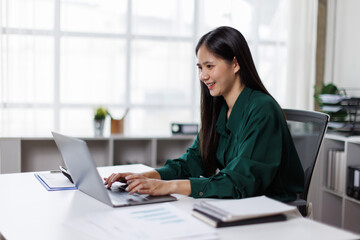 Asian business woman Auditor or internal revenue service staff checking annual financial statements...