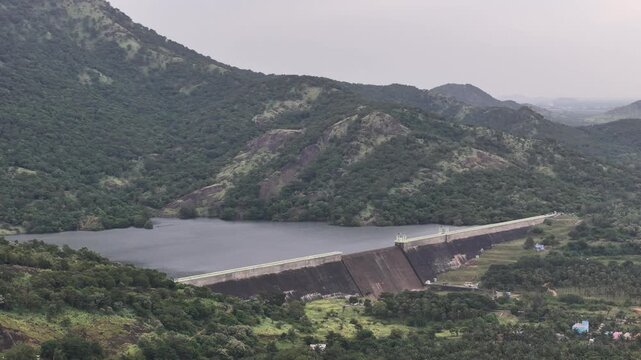 Panoramic aerial video of a mountain dam amid dense greenery and valleys near Tenkasi, showcasing the beauty of Tamil Nadu&rsquo;s Western Ghats region.