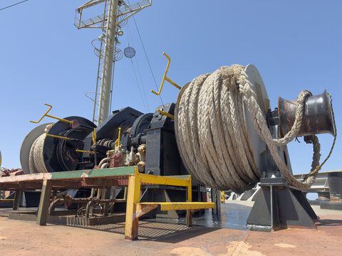 forward mooring station of cargo ship showing windlass, mooring winches, ropes, 3
