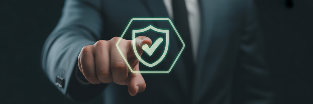A businessman touching a digital shield icon with a checkmark, representing security, protection, and trust in business and technology solutions for data privacy - Powered by Adobe