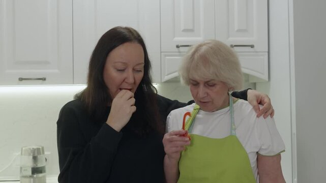 Professional chefs and family members analyzing fresh vegetables, comparing ingredients while standing in sleek white kitchen, sharing culinary knowledge and nutritional insights