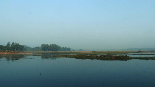 a river with fog evaporates above the water surface in the morning in winter, Peaceful sunrise besides the river, close up vedio