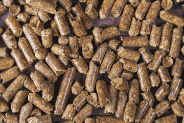 Wood pellets closely packed, creating a texture of organic biomass material used for heating and sustainable energy