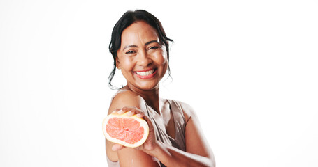 Portrait, skincare or woman with grapefruit, beauty or facial treatment with vitamin c and studio. White background, cosmetics or mature person with squeeze fruit, anti aging benefits or mockup space