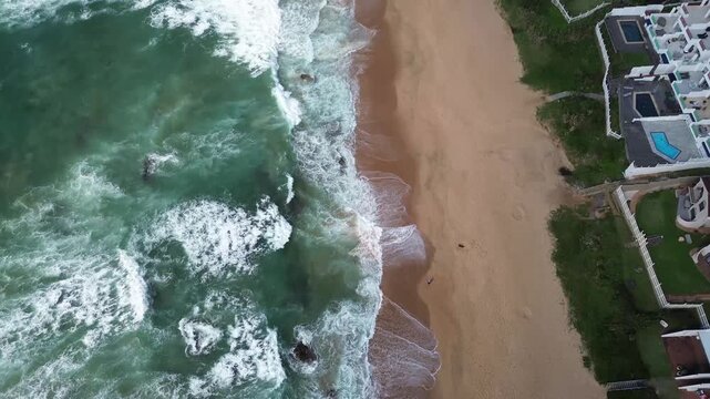 Ballito Coastal tourist town camera looking down on clean beautiful beach and beachfront holiday accomodation on the North Coast Kwazulu-Natal South Africa Aerial 4K Video