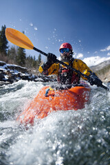Fototapeta premium Extreme kayaker navigating turbulent river rapids