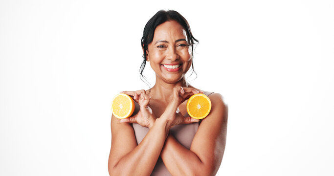 Portrait, skincare and woman with orange, happy and facial treatment with vitamin c and mockup space. White background, natural cosmetics and mature person with fruit, anti aging benefits and studio