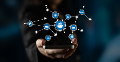 A person displays a smartphone featuring an innovative digital network graphic, symbolizing connectivity and modern technology in a futuristic environment. Tessel