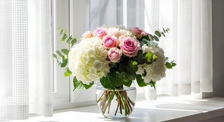 A bright bouquet of pink roses and white hydrangeas in a glass vase by a sunlit window, creating a soft and elegant home atmosphere.