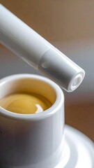 Yellow liquid in bottle, white applicator