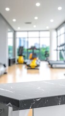 Marble table with blurry gym equipment beyond