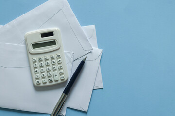 close up top view on calculator over group of invoice letter mail and from bank on wood table background for money and debt management concept