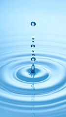 A single droplet falling and creating ripples in clear, calm water