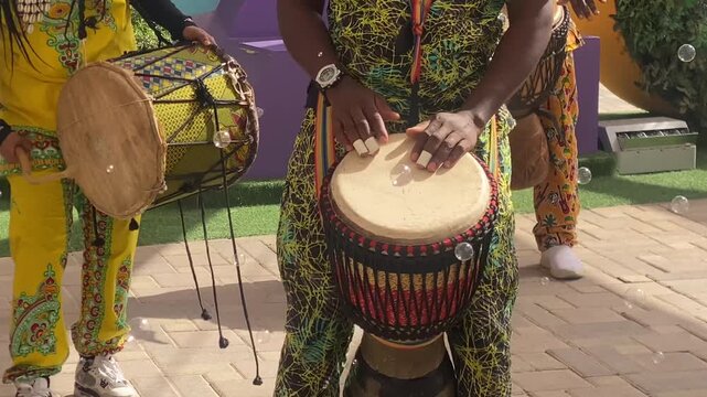 Man playing drum by his hands.performance using percussion instruments In Al Ain Zoo