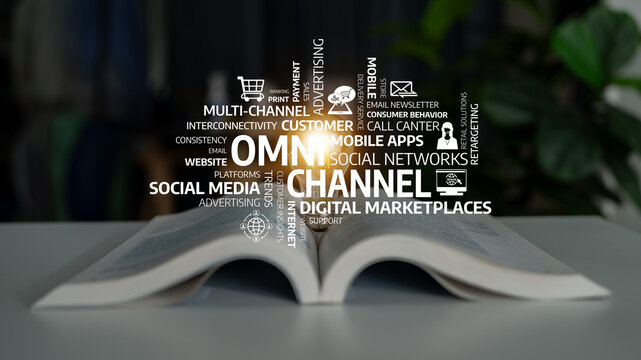 This image captures an open book with words emphasizing omnichannel marketing and digital strategies, representing innovation in advertising and consumer engagement in business. Tessel