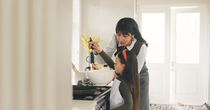 Baking, ladle or teaching with mother and daughter in kitchen of home for bonding or development. Bowl, cooking or learning with girl child and single parent woman in apartment for recipe process