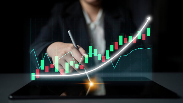 A business professional utilizes a tablet to analyze stock market trends, featuring a digital growth chart, representing financial strategies and modern technology in an office setting. Impute - Powered by Adobe