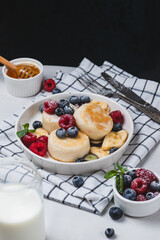 Cheesecakes with powdered sugar and berries on a plate