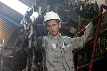 Technician worker working and checking in garage scrap yard car workshop warehouse.
